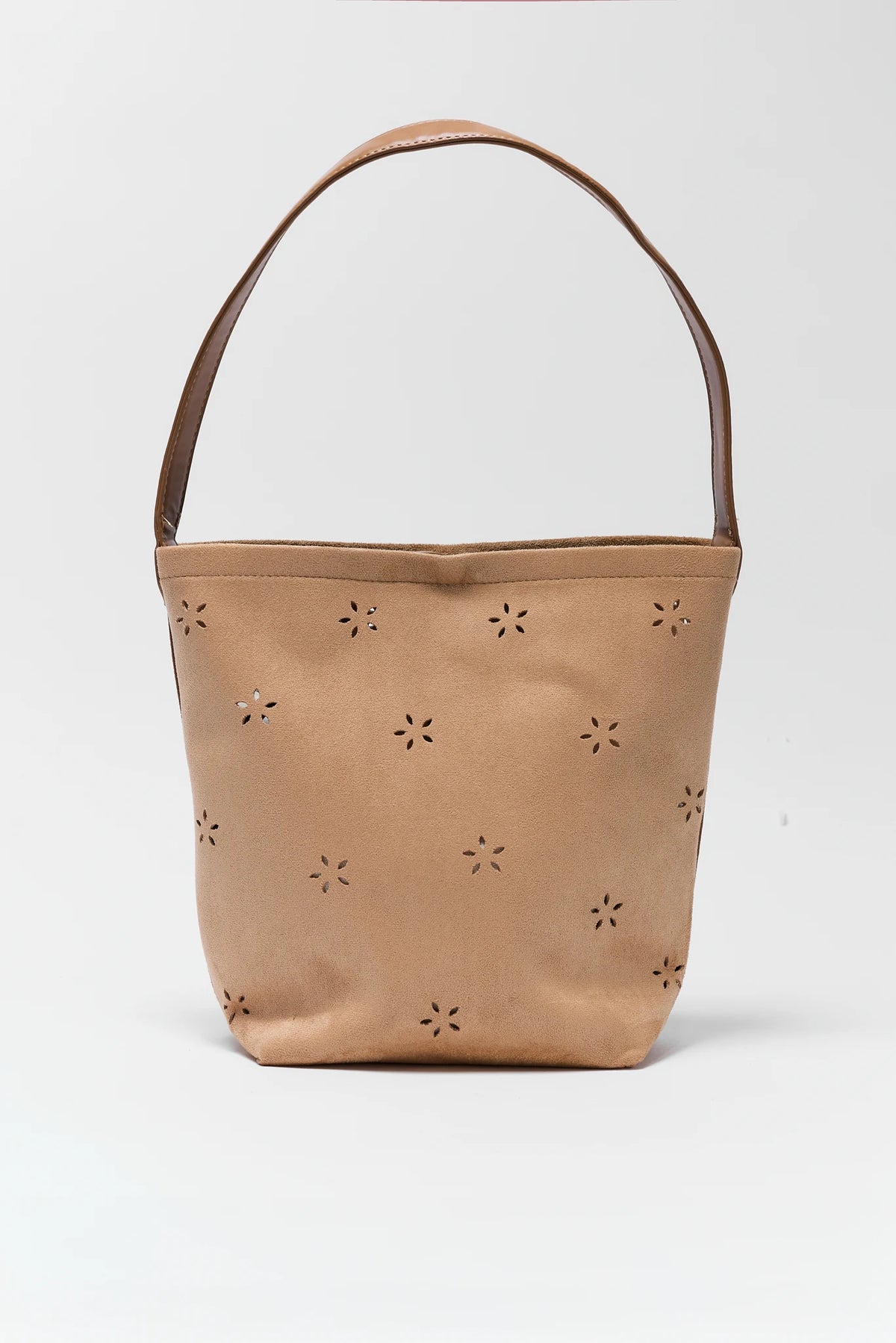 Tan bucket bag with star-shaped cutouts on a white background