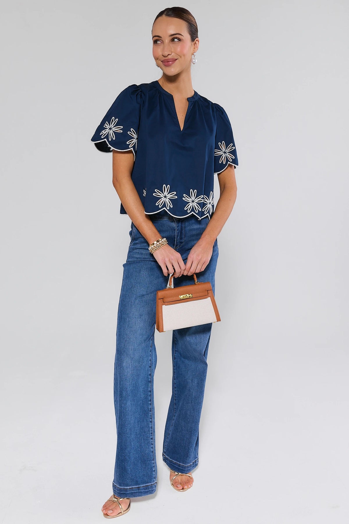 Navy embroidered top styled with wide-leg jeans and tan handbag - Full Length Styled Look | Avara