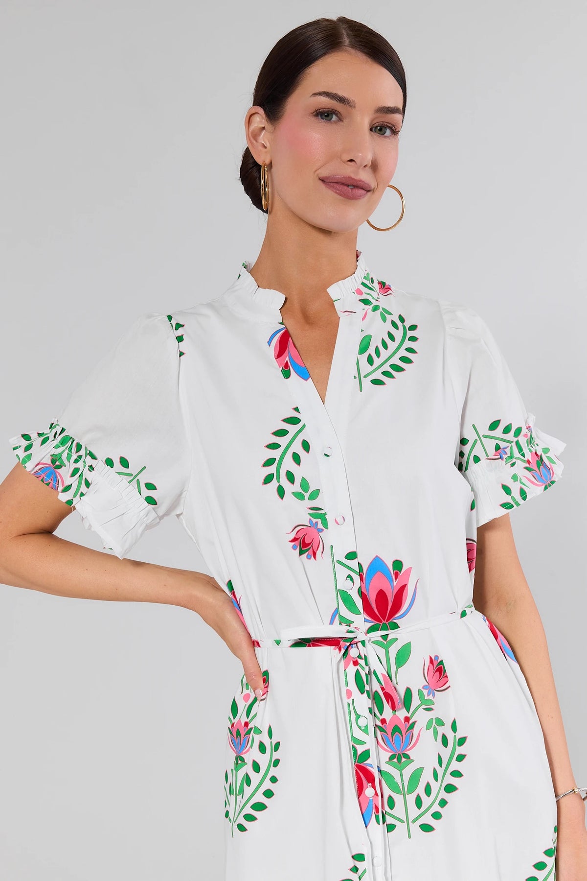 White Floral Printed Maxi Dress close-up detail, ruffled neckline and flutter sleeve with pink floral print | Avara