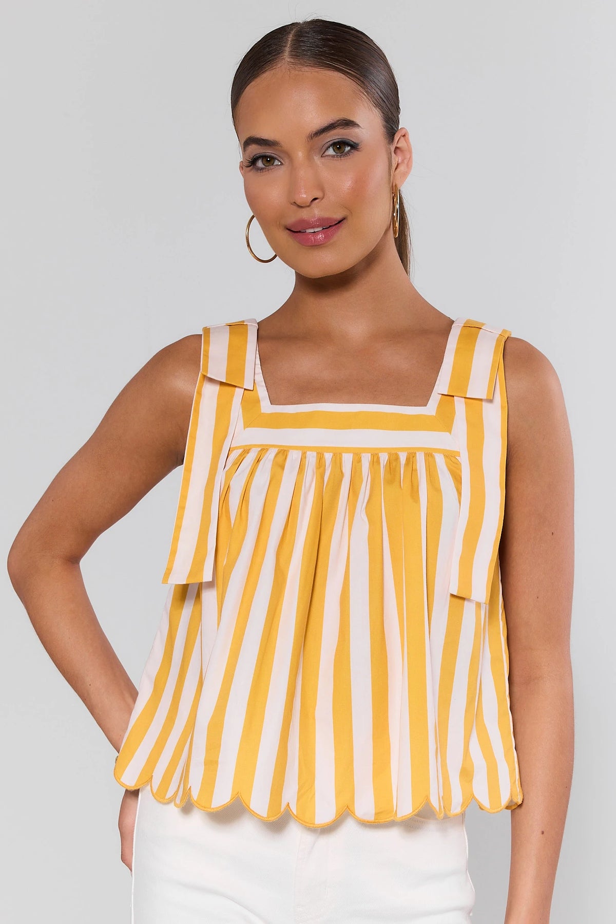 Yellow and white striped tank top with square neckline, bow shoulders, scalloped hem - Front View | Avara