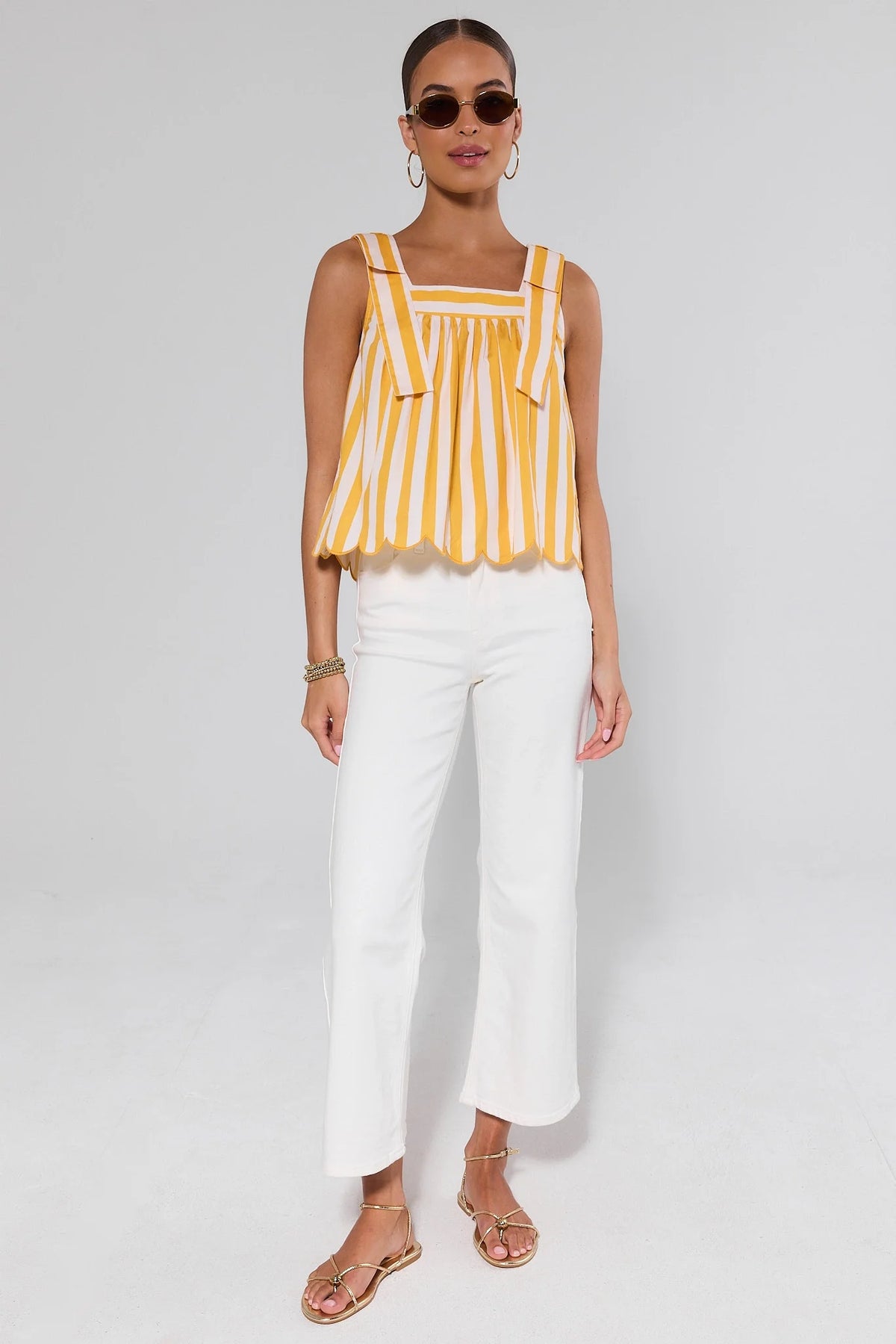 Yellow and white striped tank top styled with white wide-leg pants and gold sandals - Full Length View | Avara