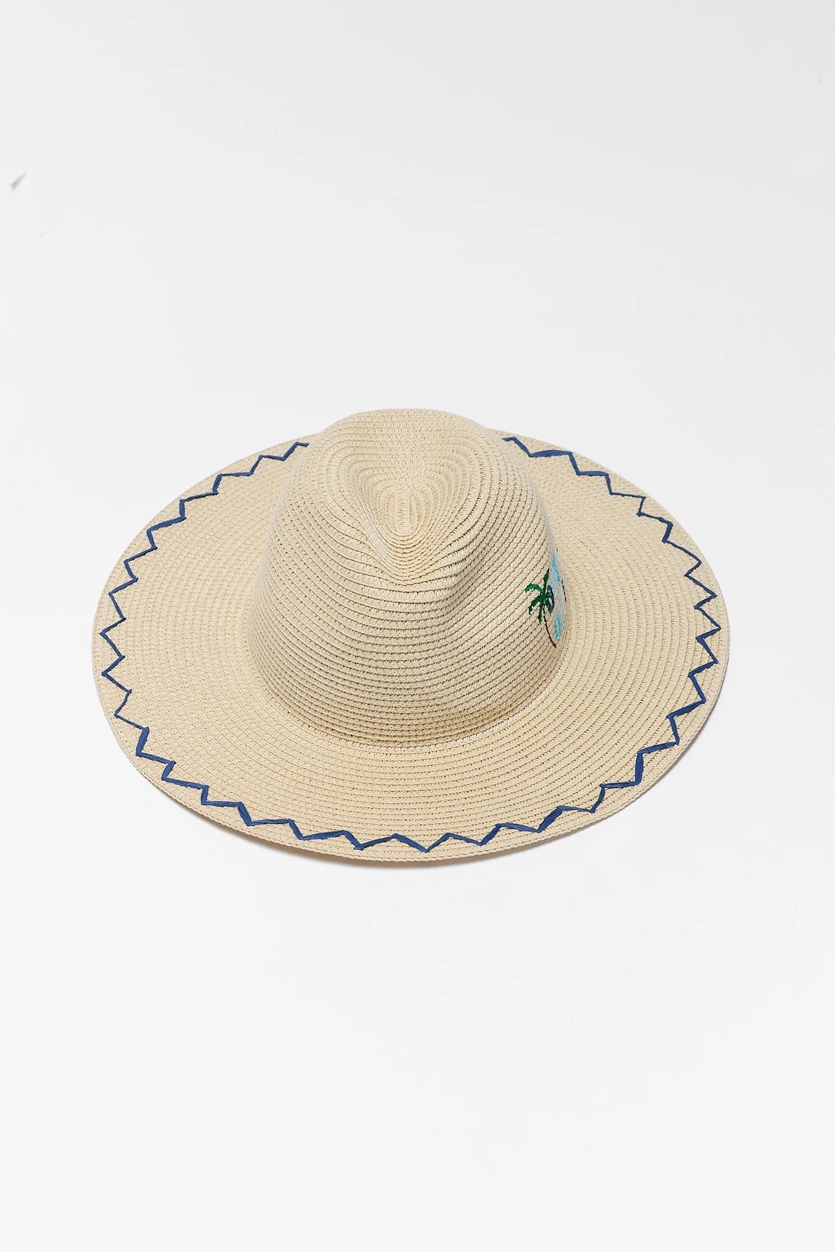 Beige raffia wide brim sun hat with navy zigzag trim and palm tree embroidery - Top-Down Flat Lay | Avara