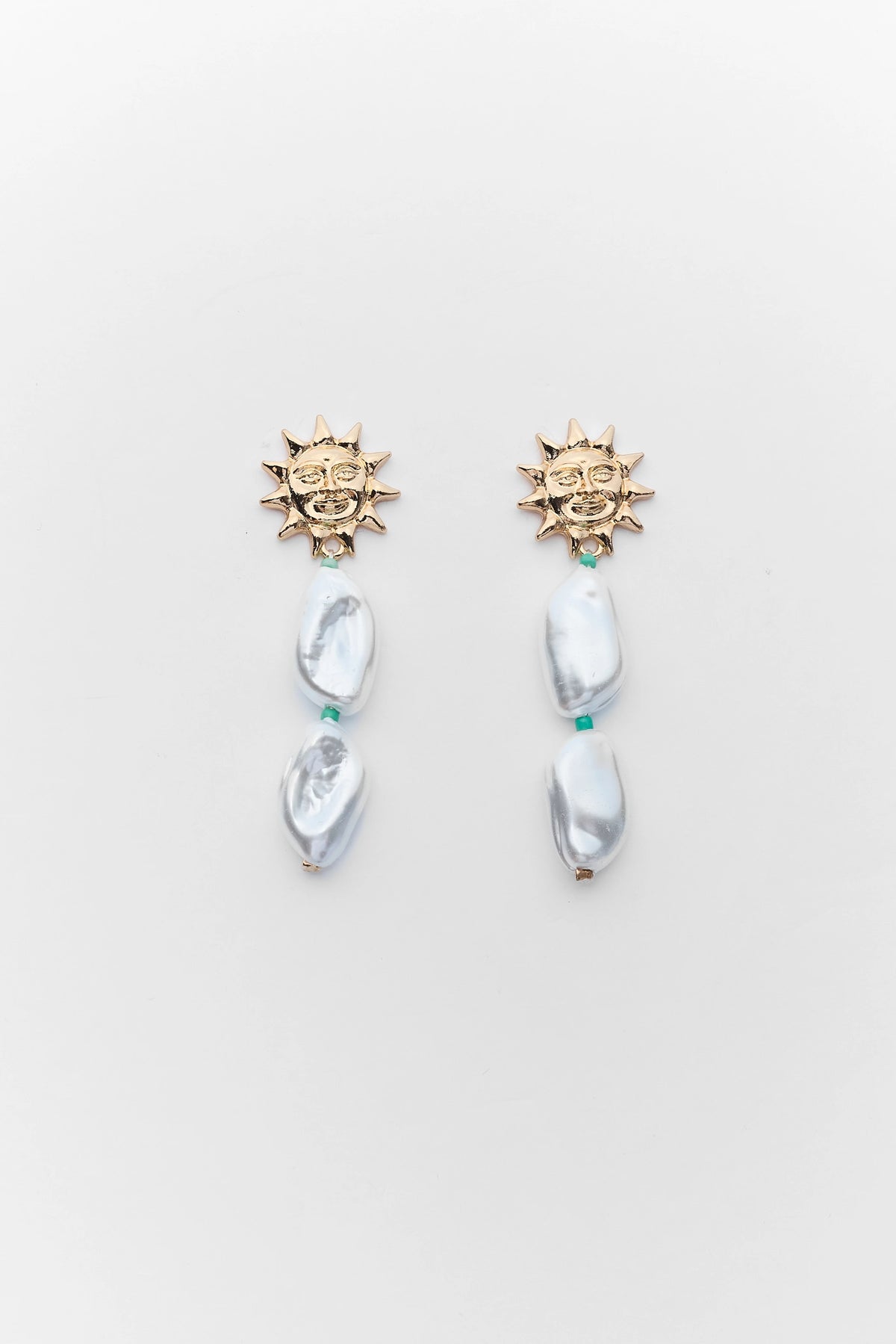 Gold Sun Charm Pearl Drop Earrings with baroque pearls and teal beads - Flat Lay | Avara