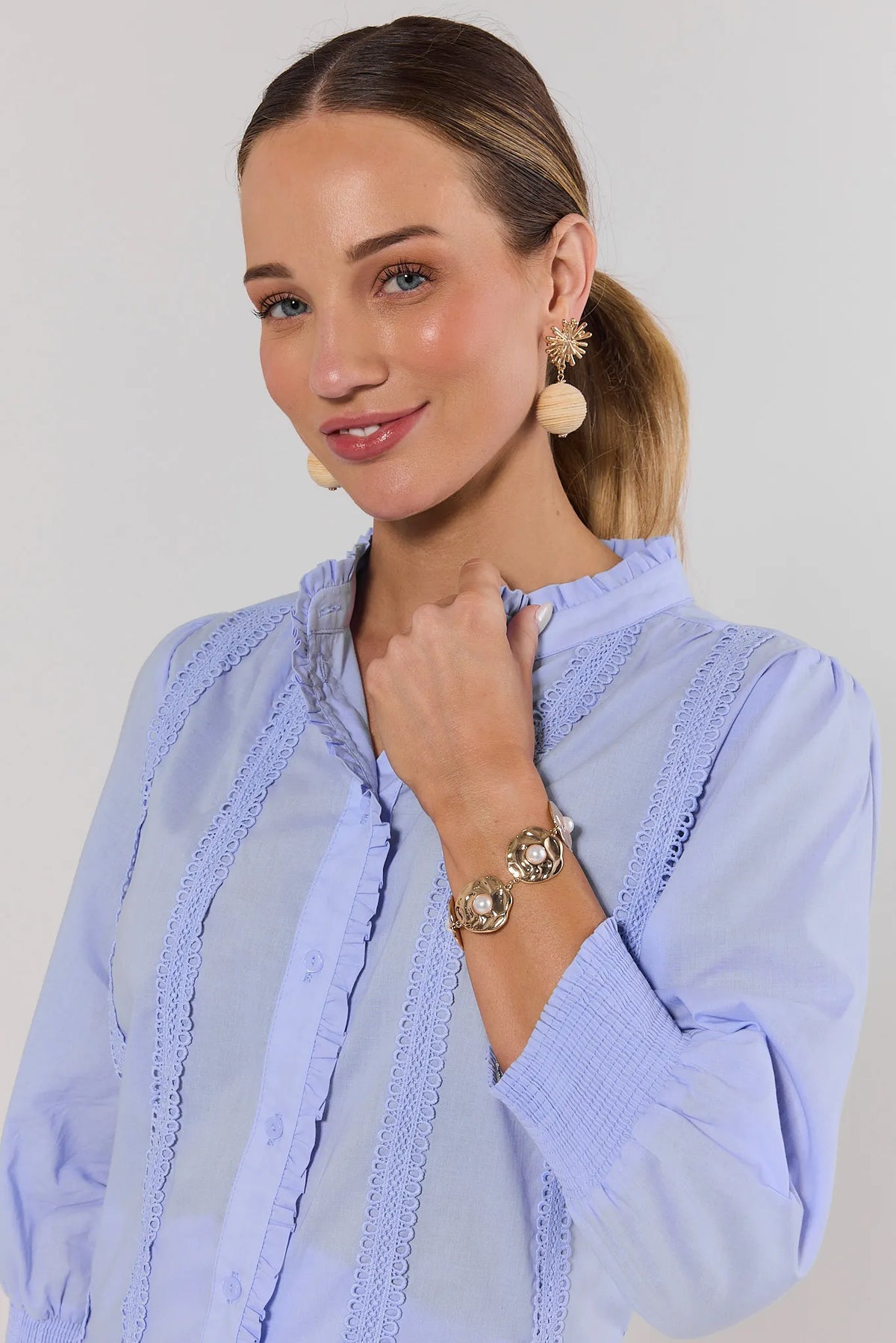 Gold chunky pearl bracelet worn on model in light blue lace blouse - On Model | Avara