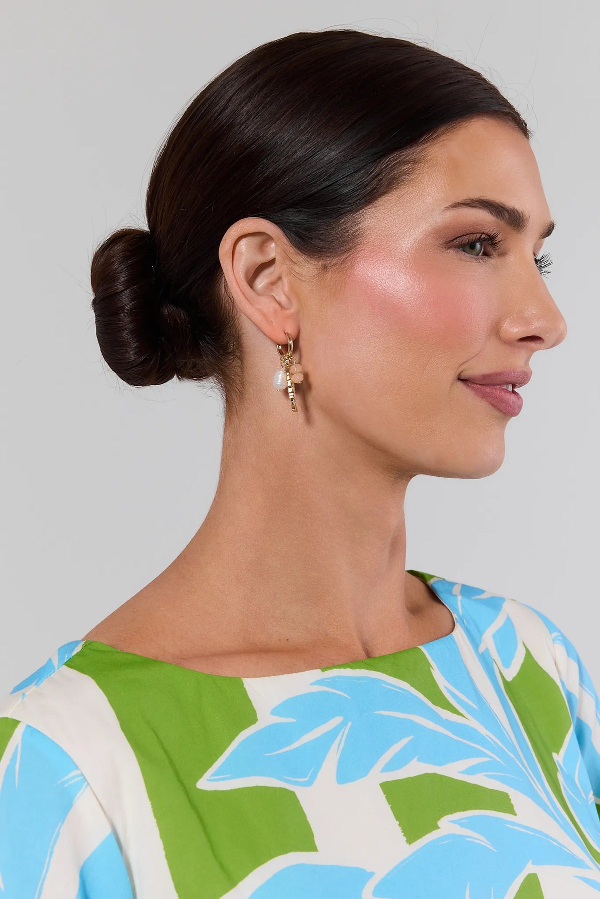 Gold charm hoop earrings with pearl bead worn on model in tropical print top - On Model | Avara