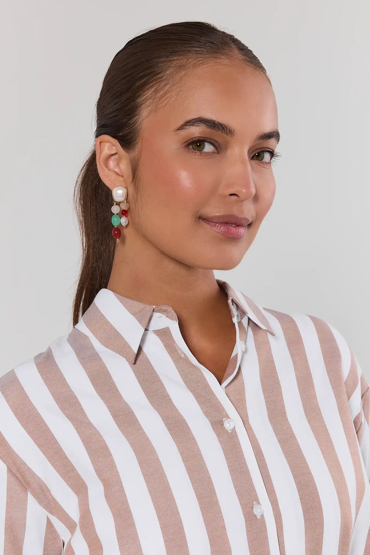 Woman wearing colorful mixed stone drop earrings with gold hardware, styled with a striped shirt - On Model | Avara