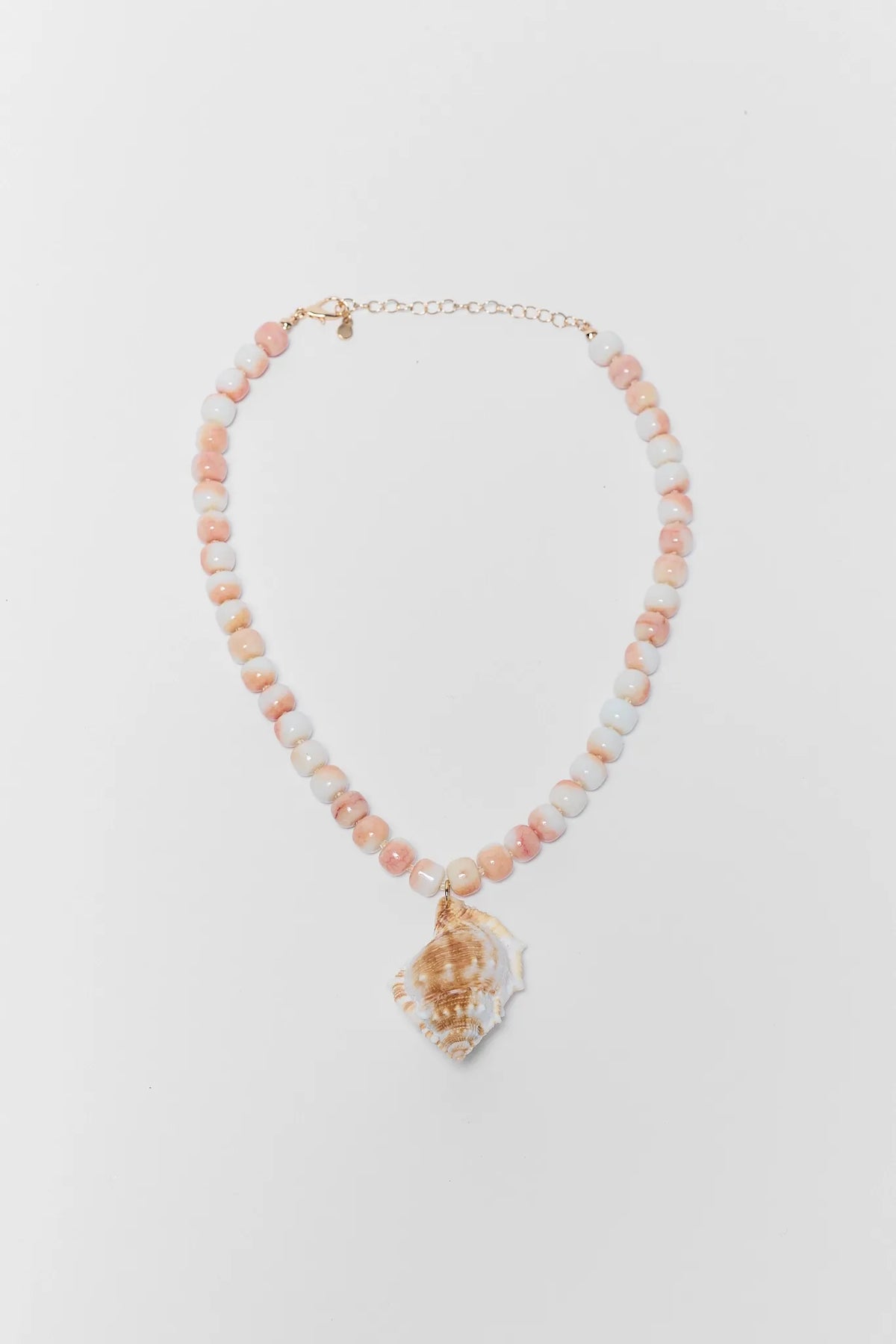 Necklace with shell pendant on a light gray background