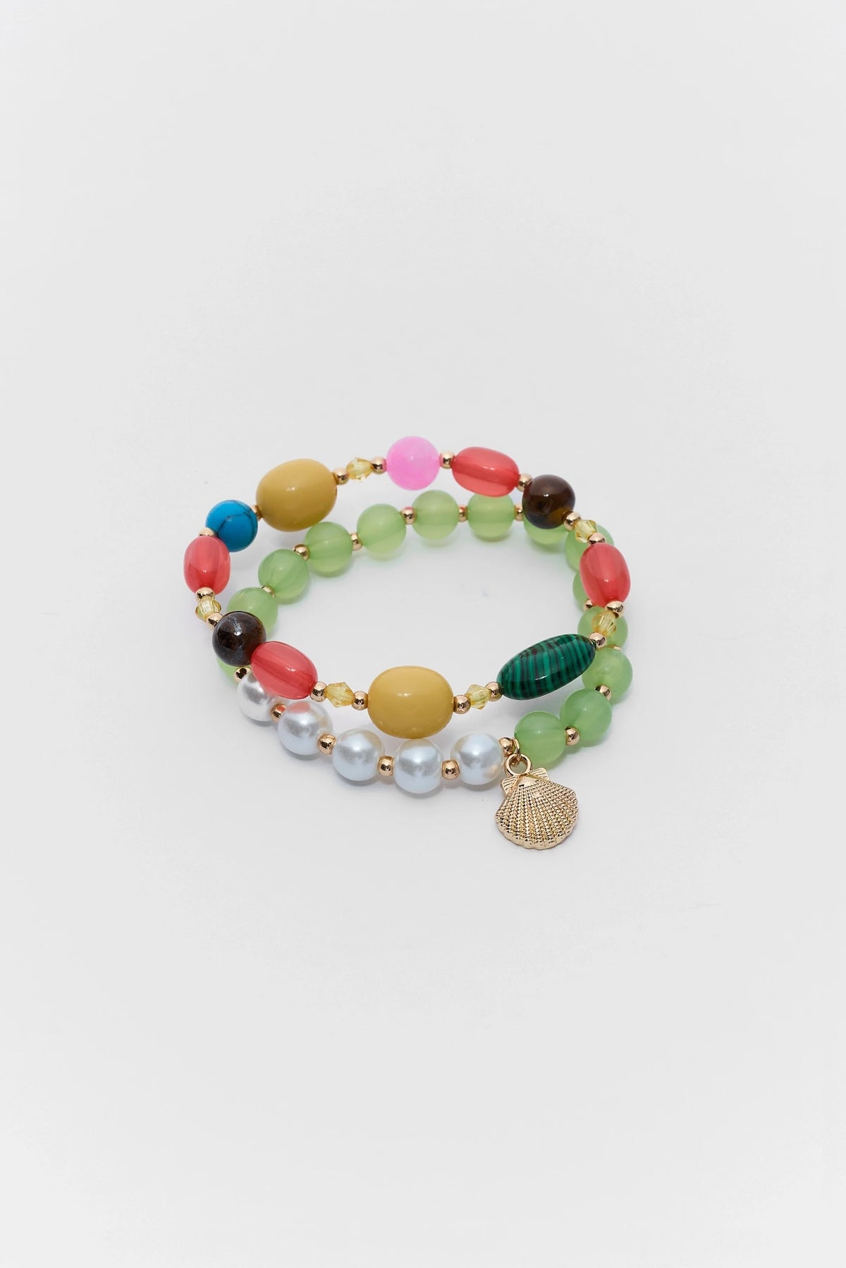 Multicolored beaded bracelet with a gold charm on a white background