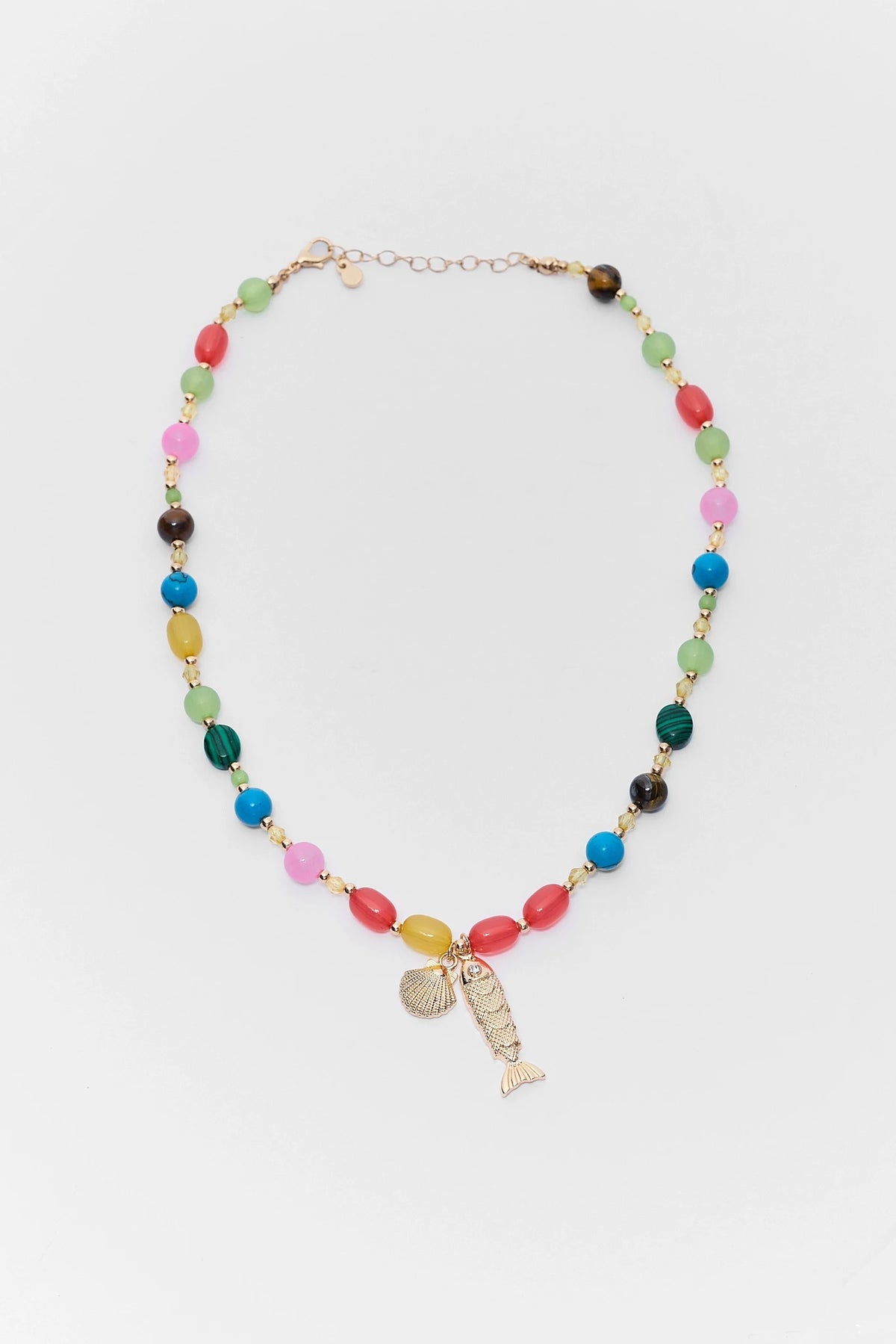 Colorful beaded necklace with a fish charm on a white background