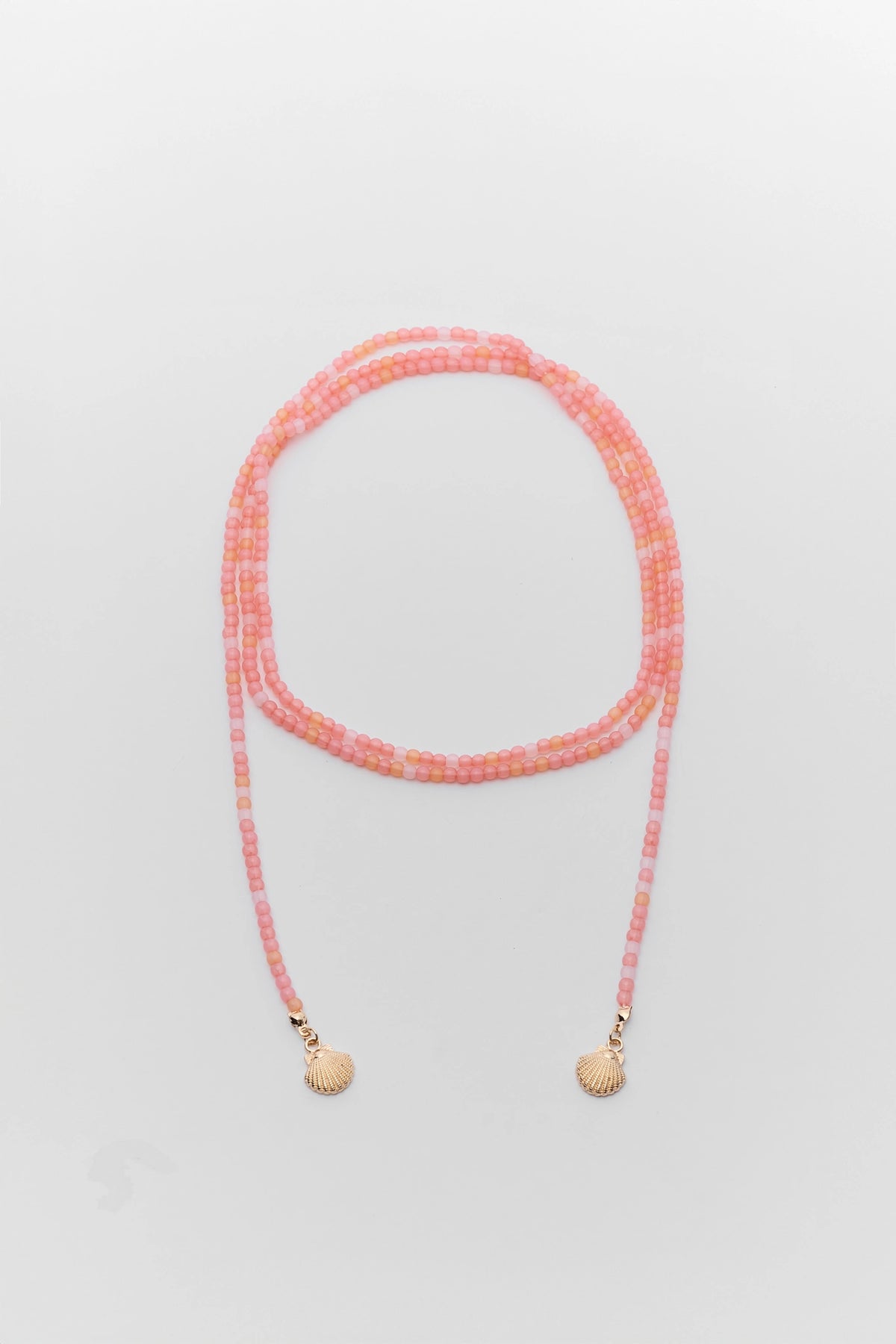 Pink beaded wrap around necklace with gold shell charms laid flat showing full length - Flat Lay | Avara