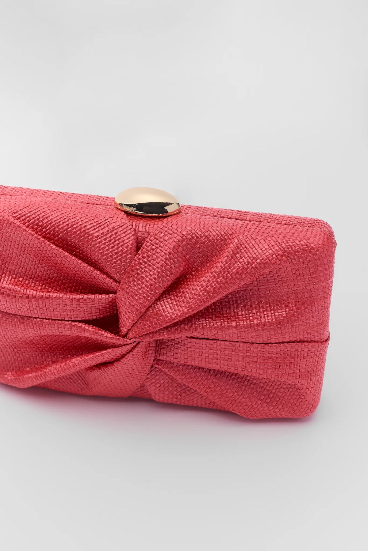 Pink woven textured knotted clutch bag with gold dome closure - Close-Up Detail | Avara