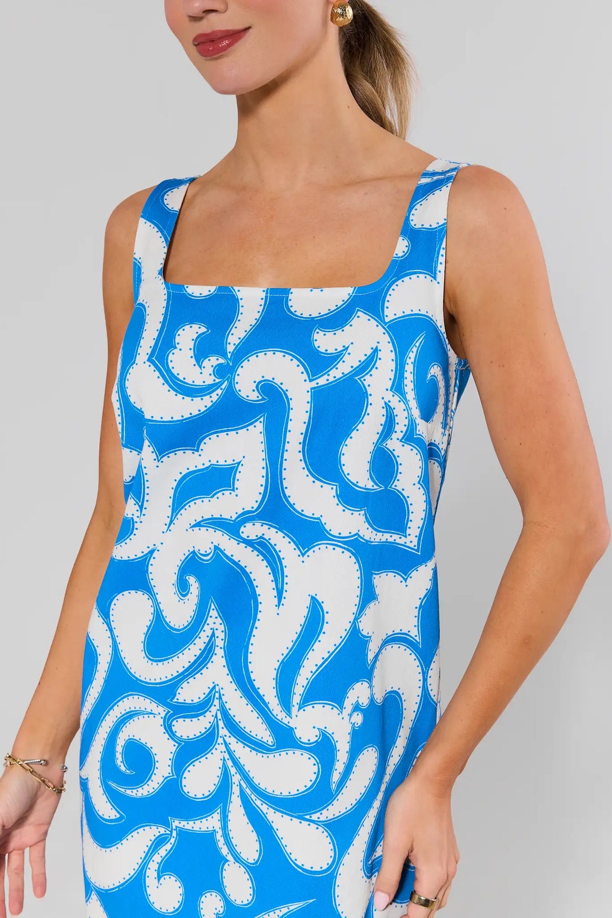 Close-up of blue printed square neck dress bodice detail, bold swirl print | Avara