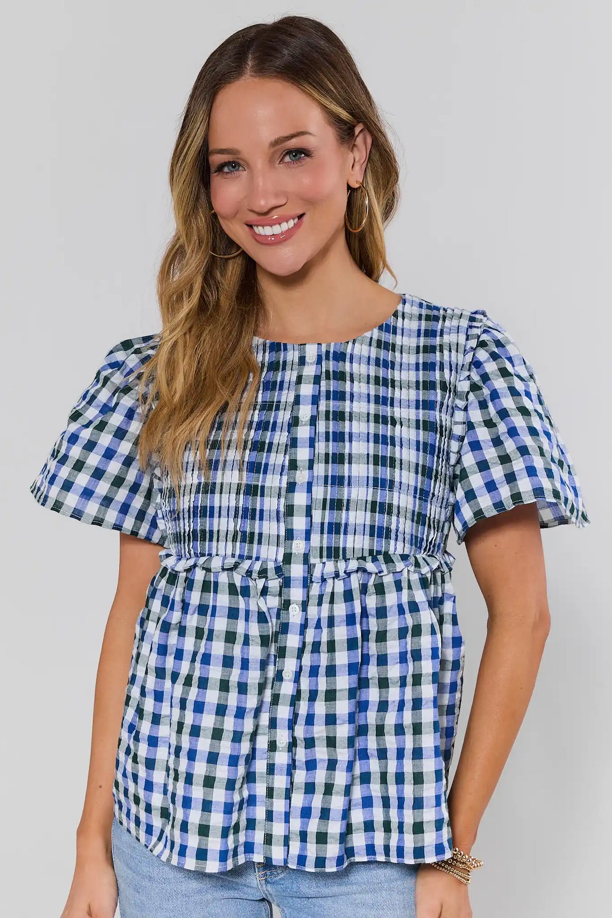 Navy gingham pleated peplum top with smocked waist and puff sleeves - Front View | Avara