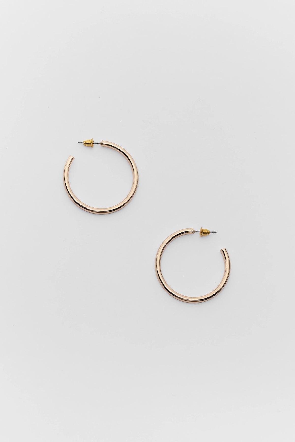 Emily Gold Small Hoop Earrings with push-back closures - Flat Lay | Avara