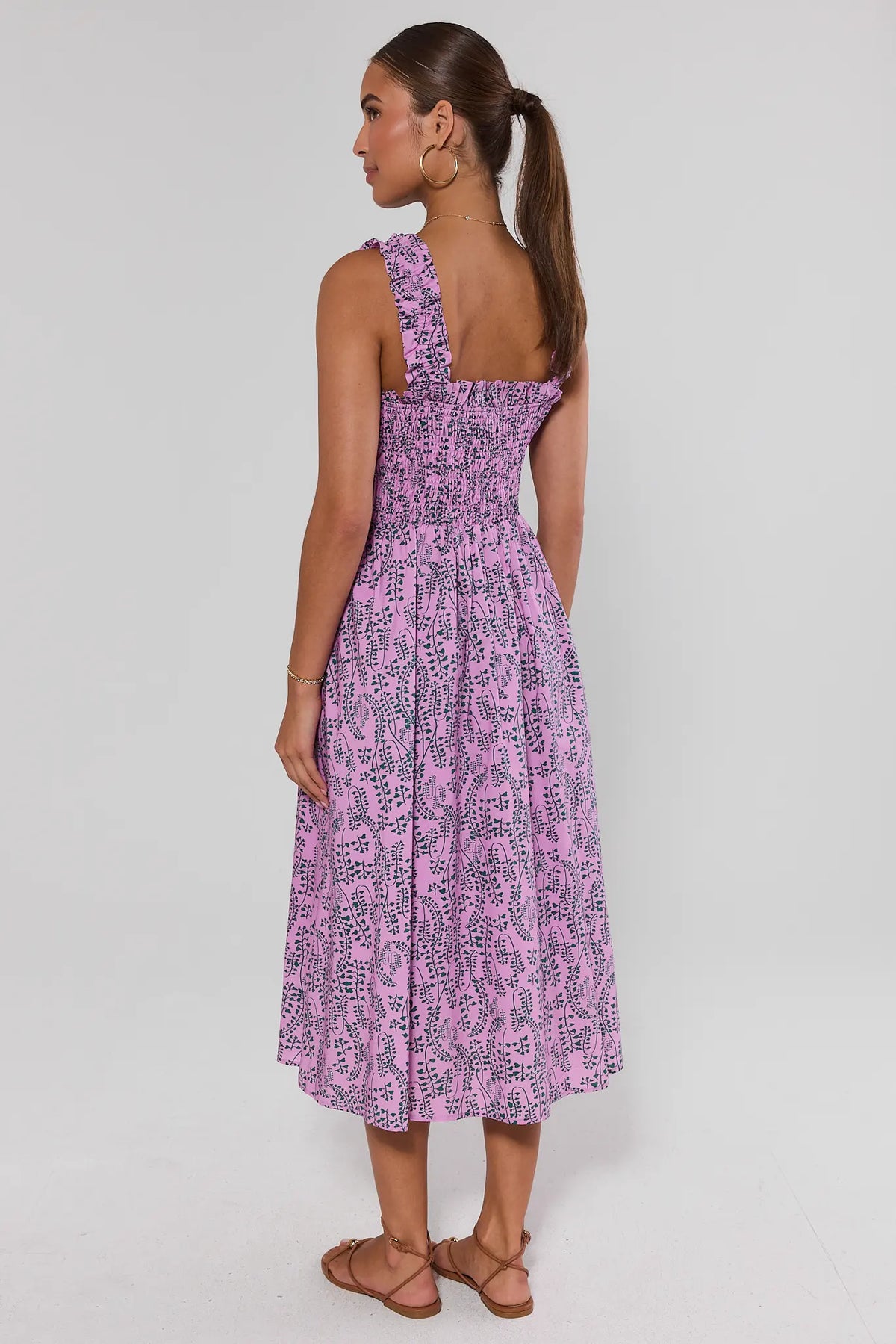 Pink Smocked Midi Dress back view showing smocked bodice and flowy midi skirt length, green vine print | Avara