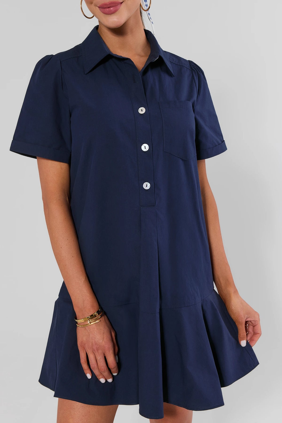 Meagan Navy Drop Waist Dress button-front bodice and flared ruffle hem - Close-Up Detail | Avara