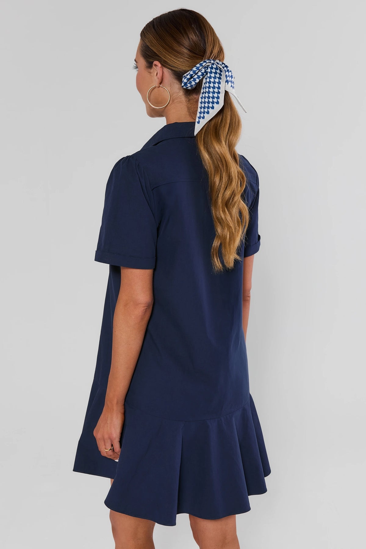 Meagan Navy Short Sleeve Drop Waist Dress with ruffle hem and gingham hair tie - Back View | Avara