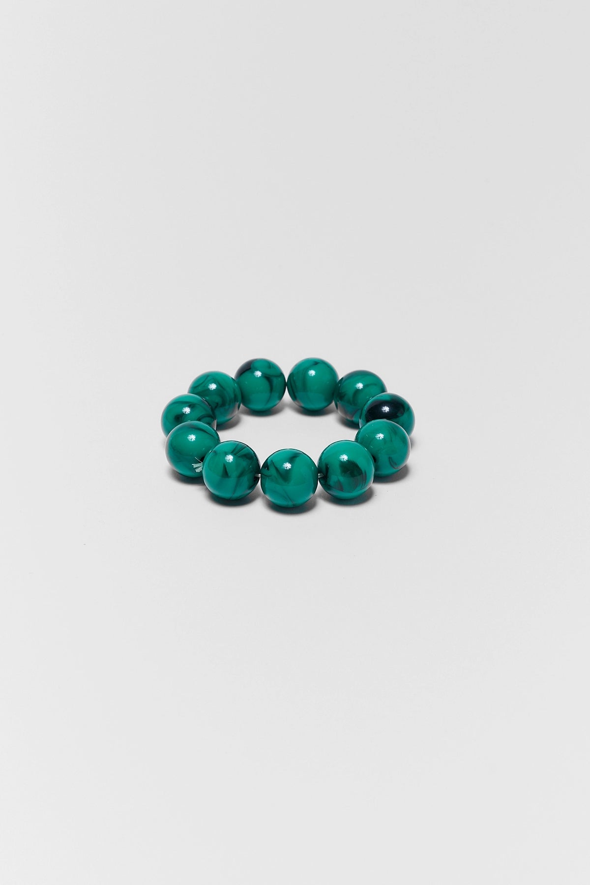 Green beaded bracelet on a white background
