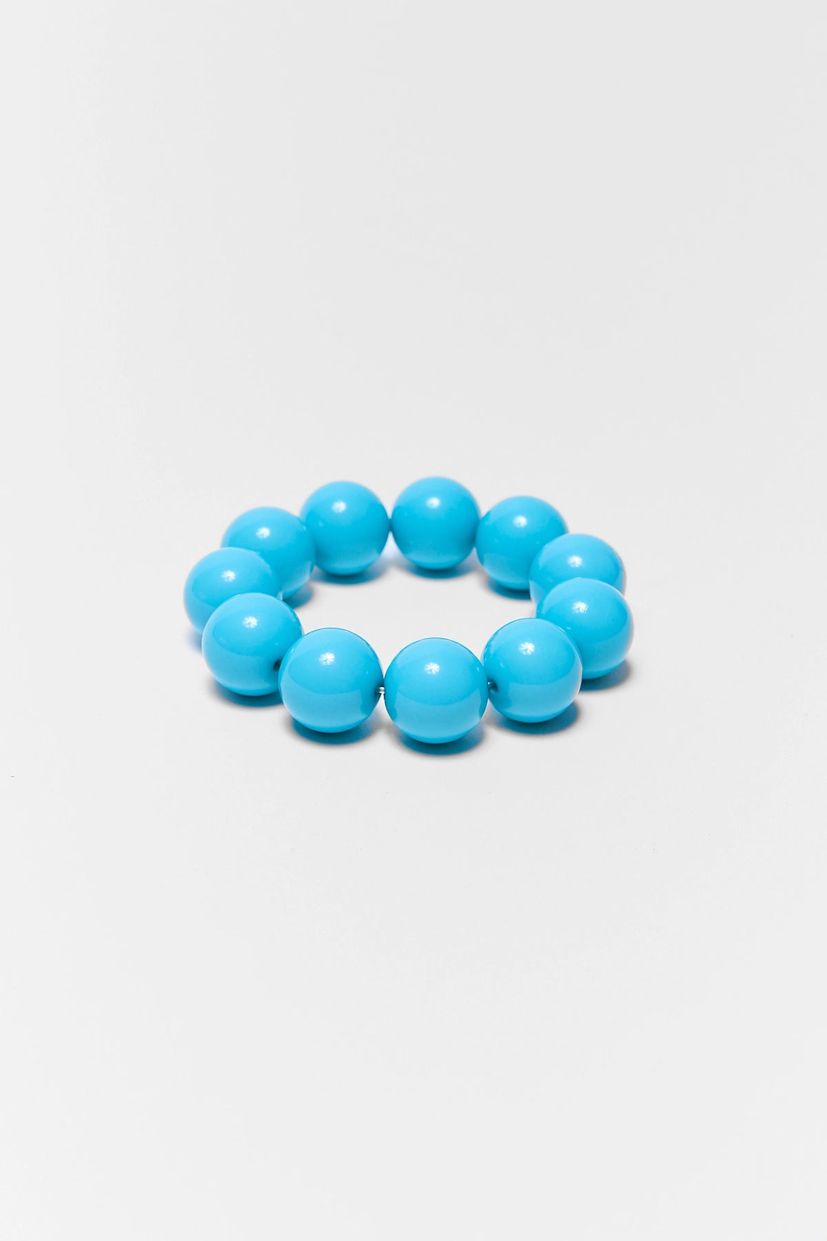 Turquoise beaded bracelet on a light gray background