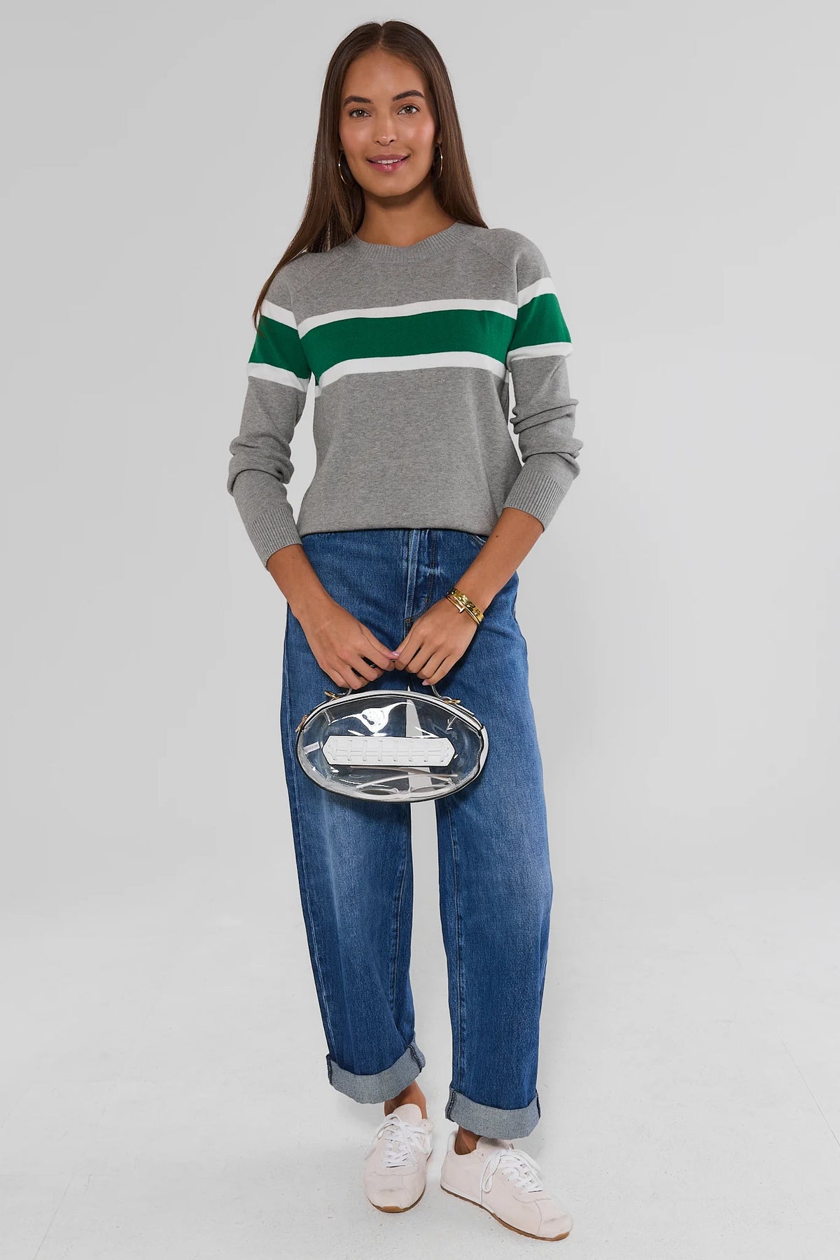 Dylan Green Stripe Sweater with jeans, white sneakers, and clear clutch - Full Length Front View | Avara