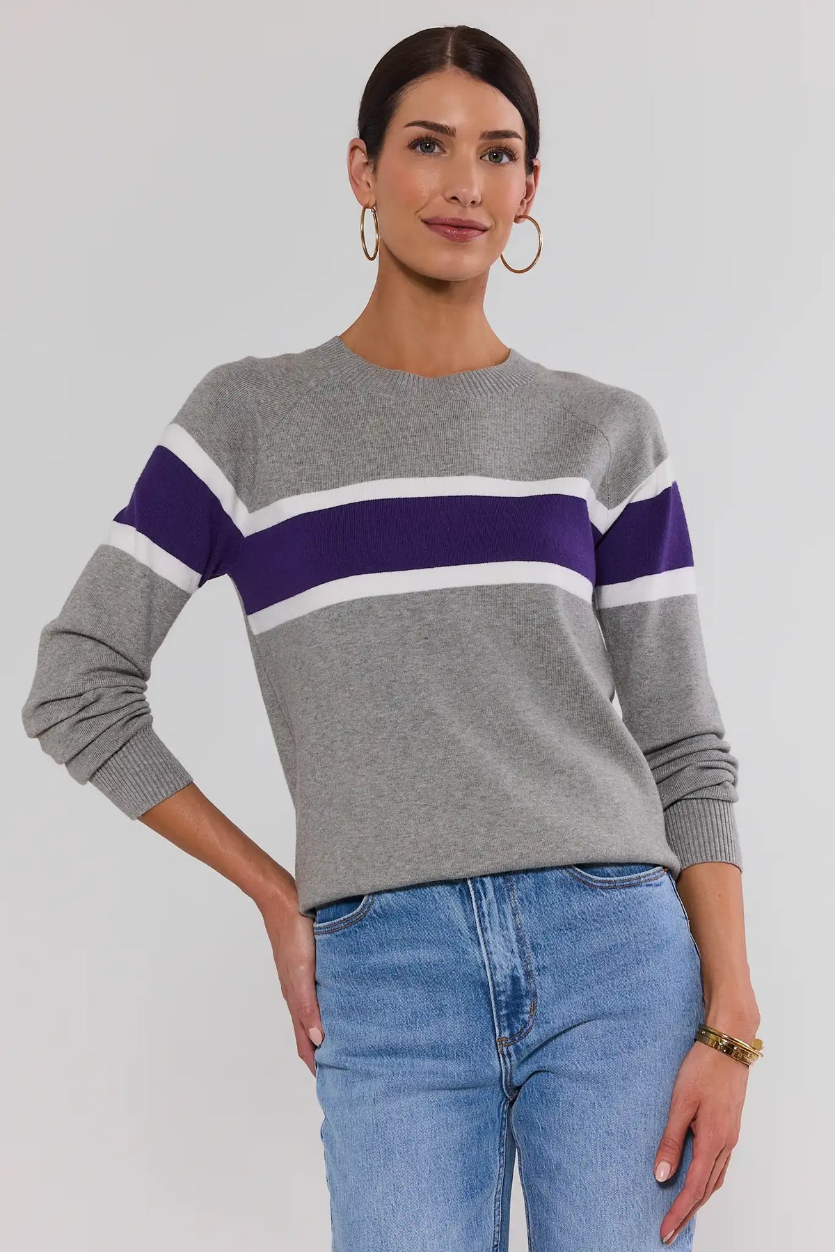 Dylan Purple Stripe Sweater in heather gray with bold purple and white chest stripes, front view on model with jeans | Avara