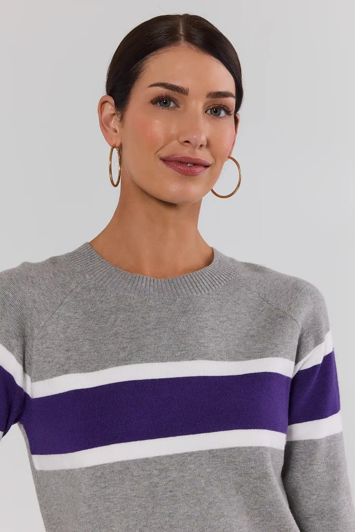 Dylan Purple Stripe Sweater close-up detail of crewneck and purple and white stripe pattern, gold hoop earrings | Avara