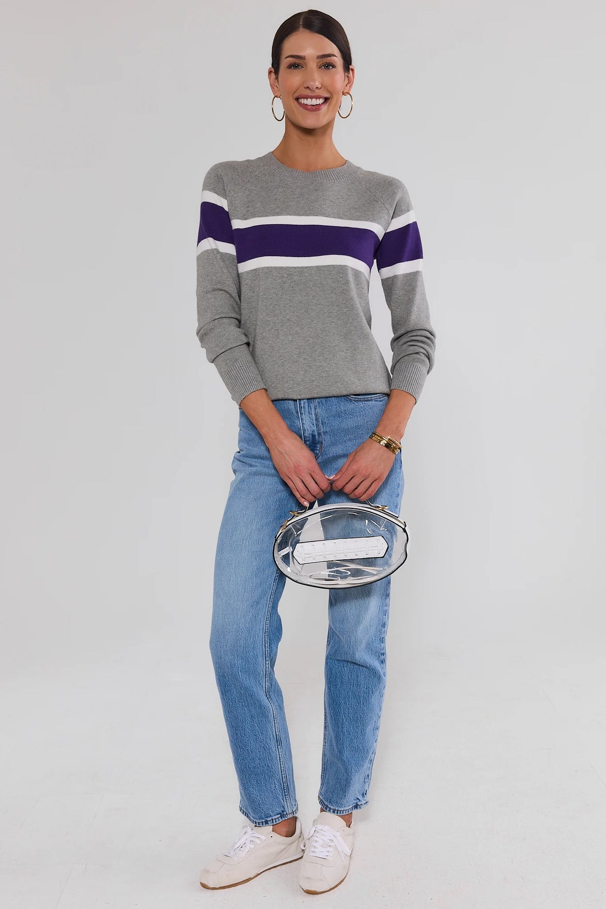 Dylan Purple Stripe Sweater styled with light wash jeans, white sneakers, and clear stadium bag — game day outfit | Avara
