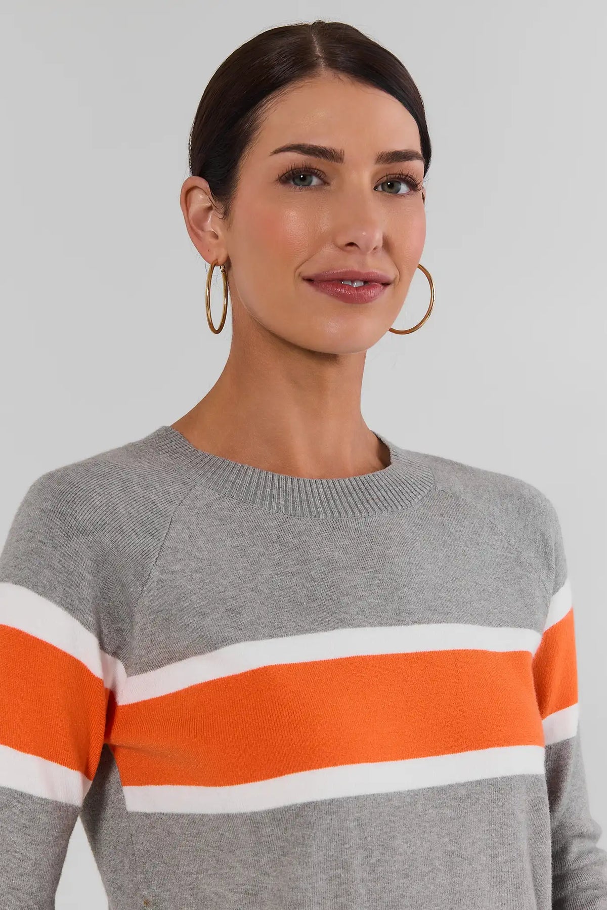 Dylan Orange Stripe Sweater crewneck close-up with gold hoops - Front Detail | Avara
