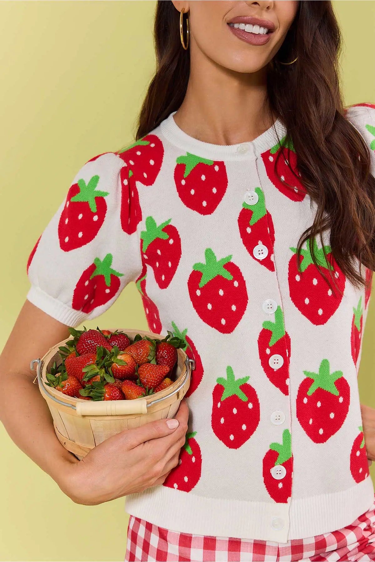 Woman in white strawberry knit sweater holding basket of strawberries, styled with gingham - Lifestyle | Avara