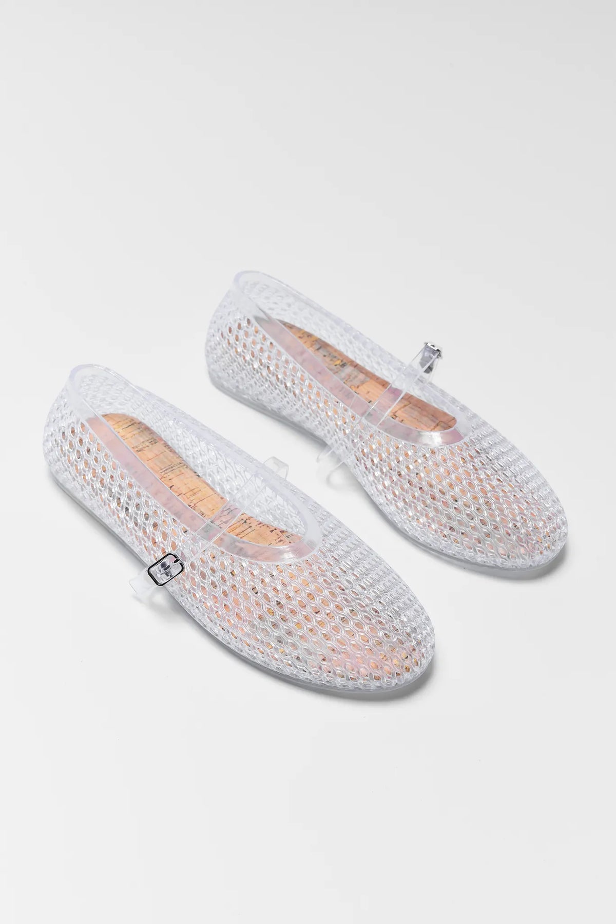 Pair of Sally Clear Jelly Flats on a light gray white background