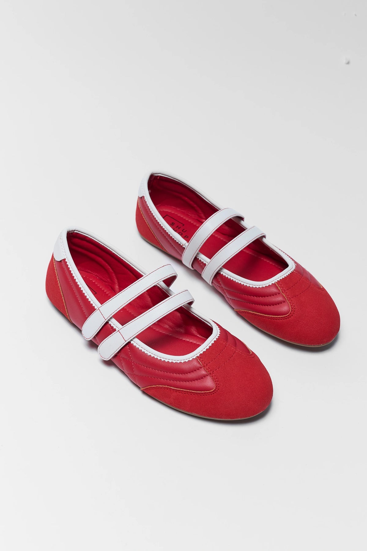 two red flat sneakers