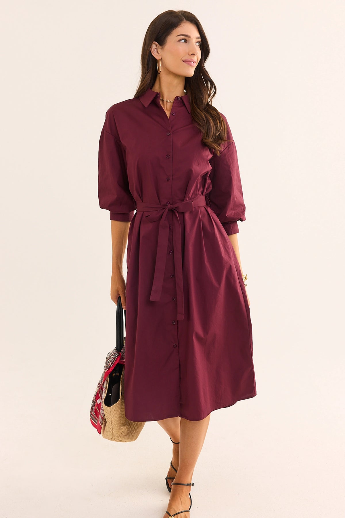 Summerlyn Burgundy Midi Dress - modest shirt dress with three-quarter puff sleeves, belted waist, styled with sandals and tote | Avara