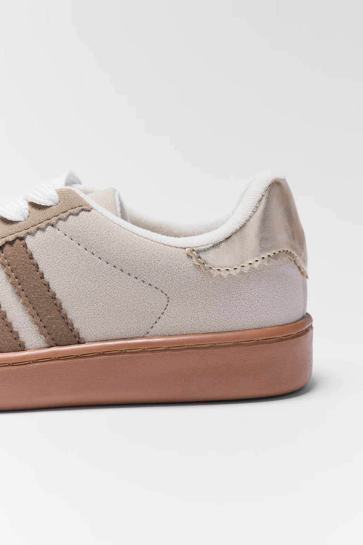 Sylvie Tan Striped Sneakers suede upper, tan stripe, and gold metallic heel counter - Close-Up Detail | Avara