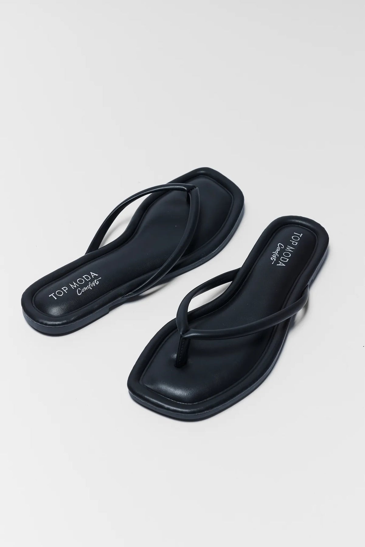 Black Faux Leather Flip Flop Sandals - Angled Pair View | Avara