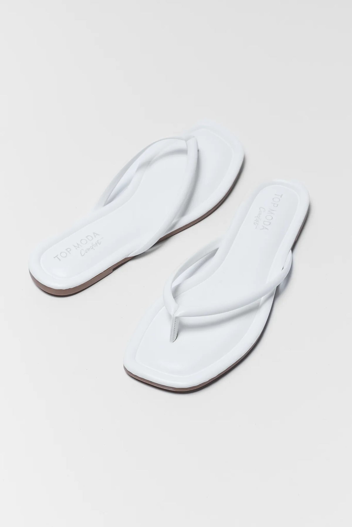 Taite White Square Toe Flip Flop Sandals - Angled Pair View | Avara