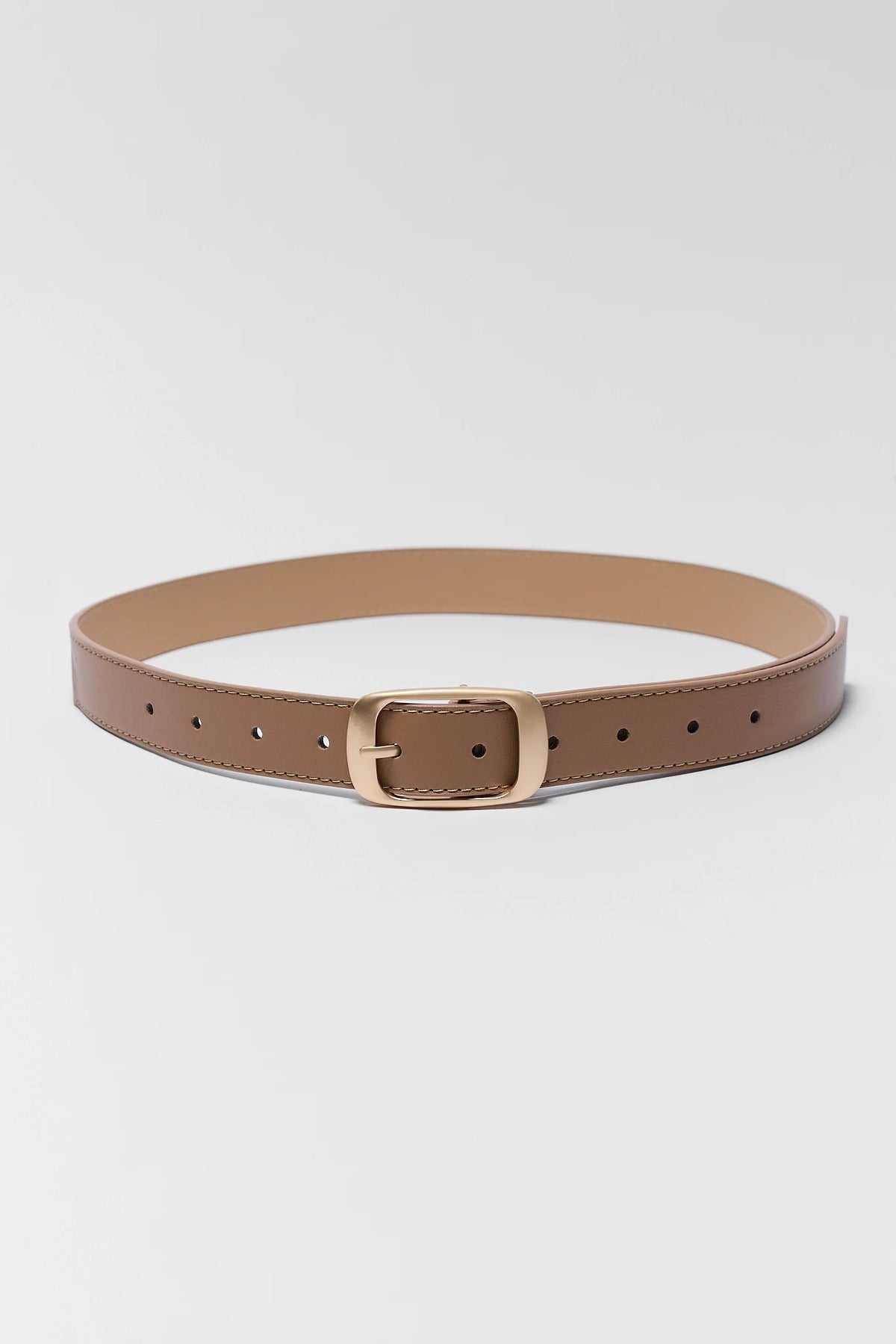 Tan faux leather belt with brushed gold buckle, laid flat showing adjustable holes, front view | Avara