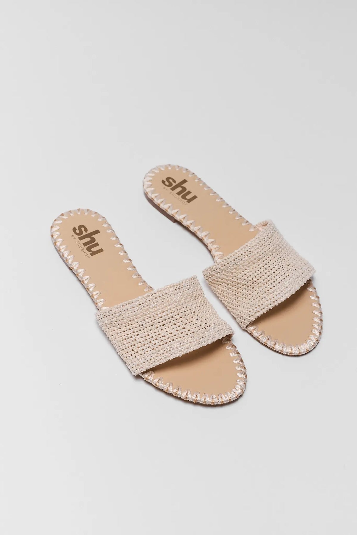 Tan Raffia Slide Sandal pair with woven band and stitched trim, top-down view | Avara
