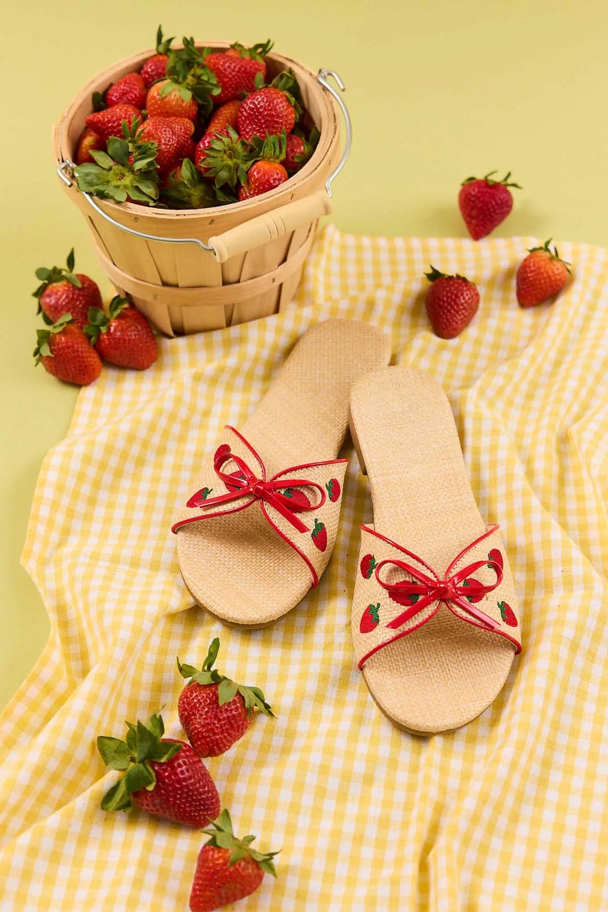 Tan raffia strawberry sandals women styled on yellow gingham with fresh strawberries - Lifestyle | Avara