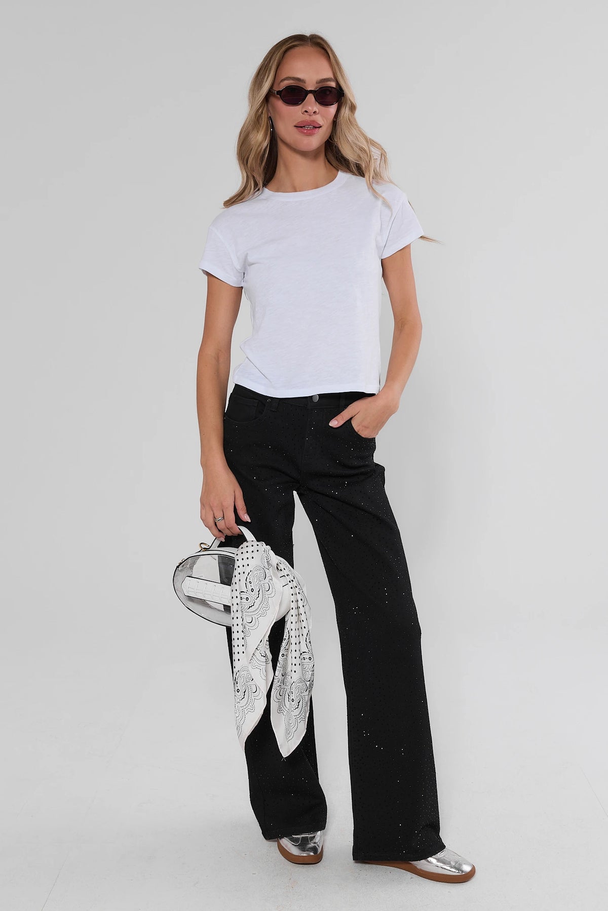 Styled look: Carrie Black Rhinestone Wide Leg Jeans with white tee, printed scarf, and silver flats | Avara