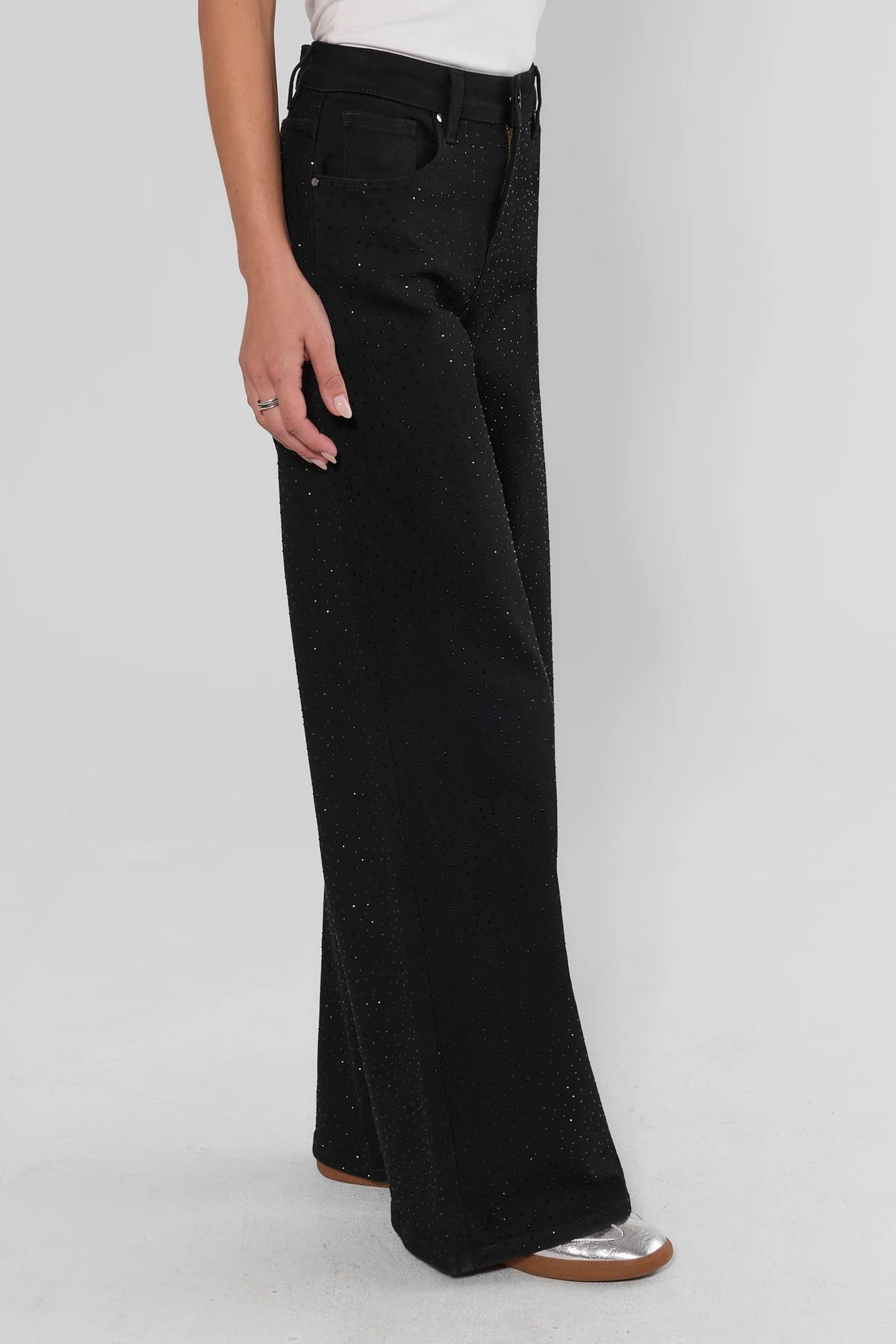 Black rhinestone wide leg jeans side profile on model with silver flats showing full-length silhouette | Avara
