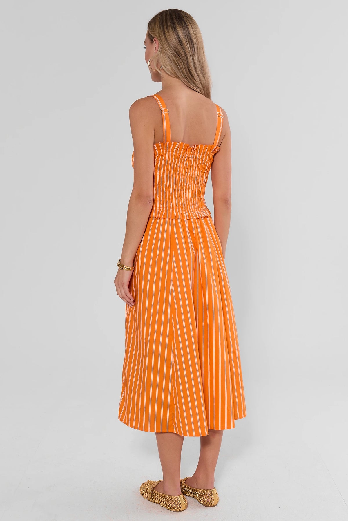 Orange striped smocked midi dress showing adjustable back straps and smocked bodice - Back View On Model | Avara