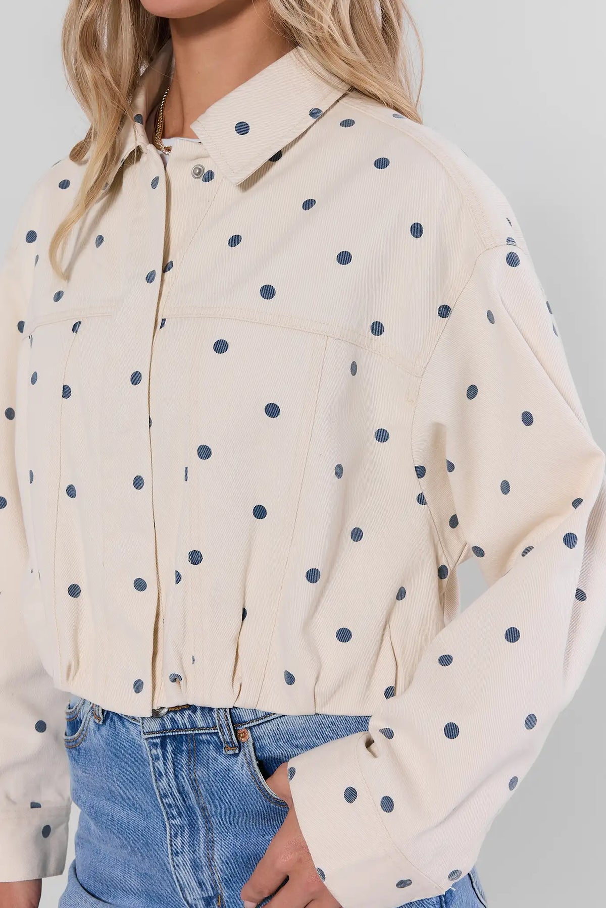 White Polka Dot Cropped Denim Jacket close-up detail, navy dot print and collar, layered over white tee | Avara