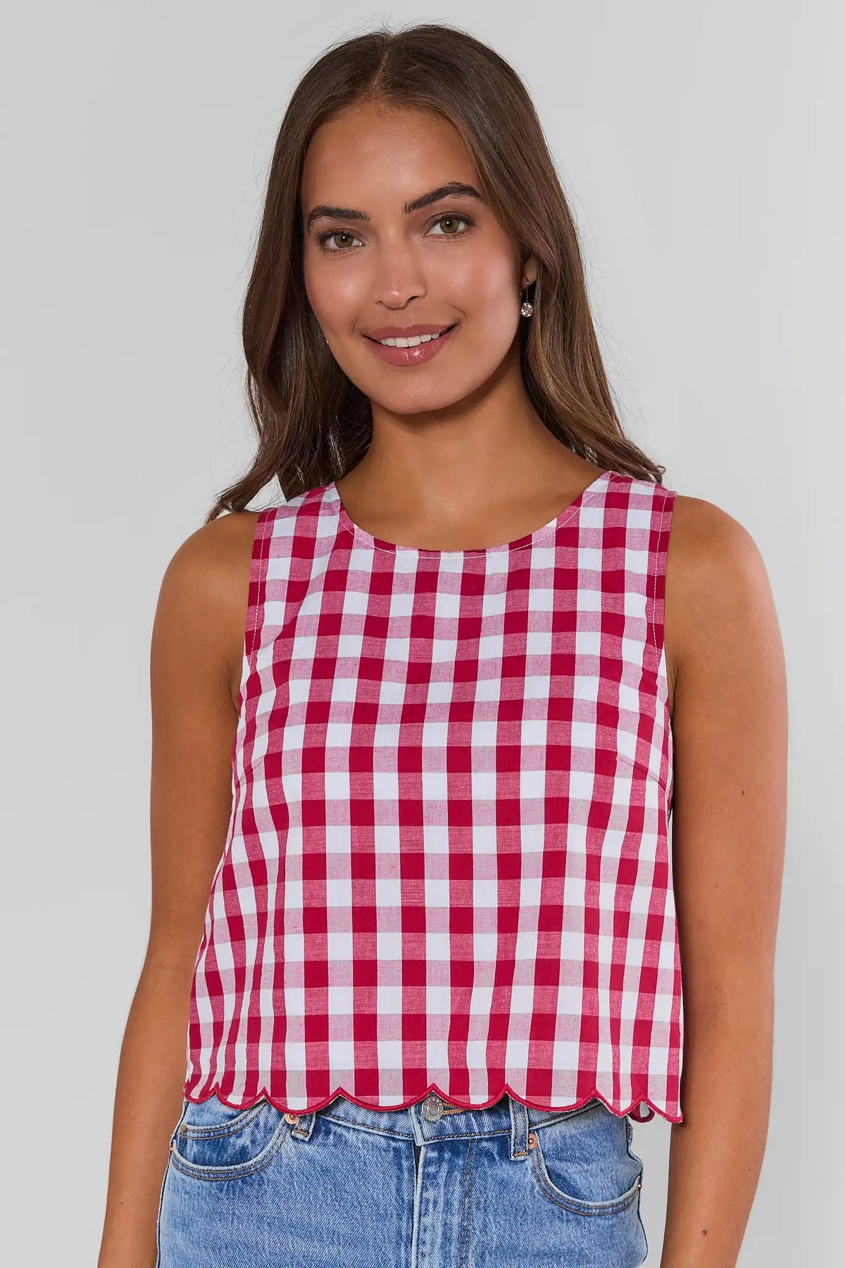 Red gingham scalloped tank top on model, front view, paired with blue jeans | Avara