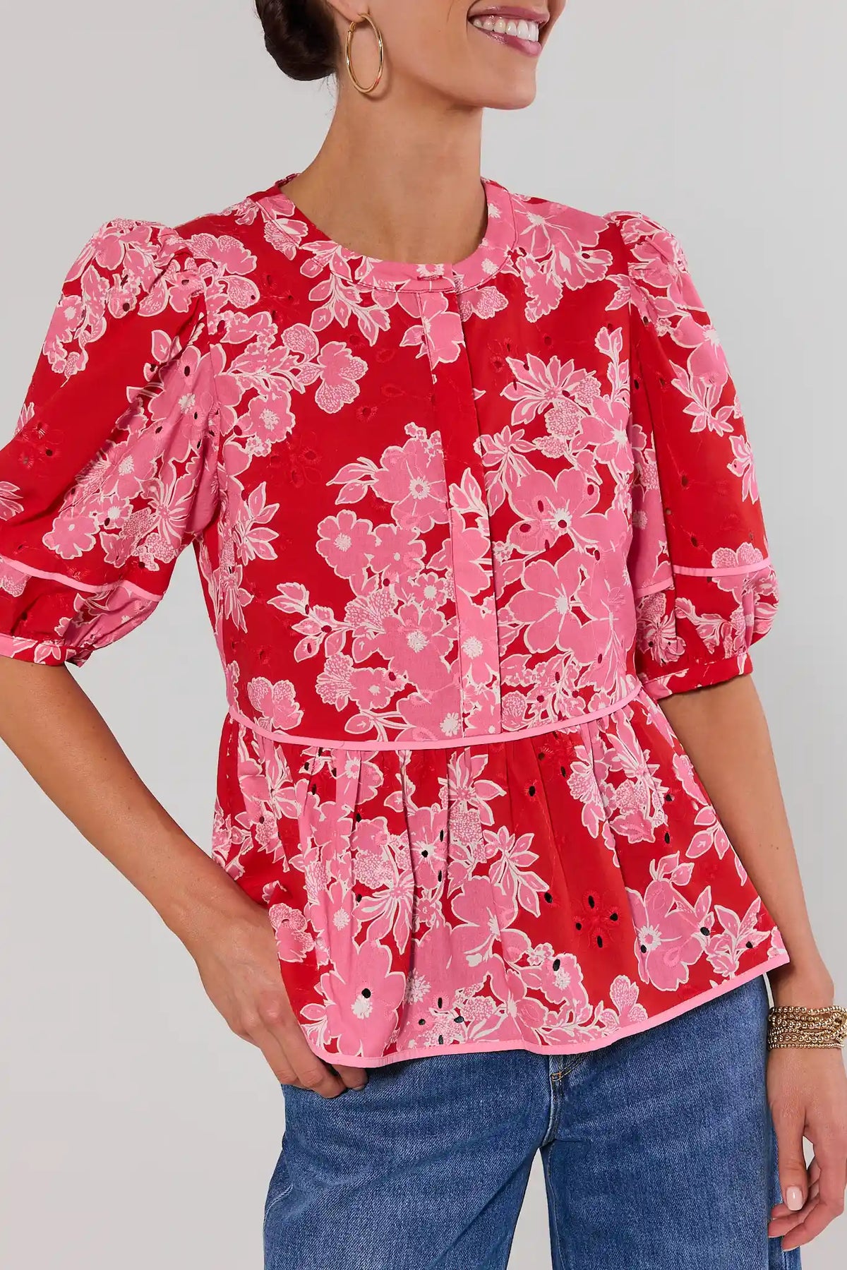 Close-up of red floral eyelet peplum top showing pink floral embroidery and peplum waist detail | Avara