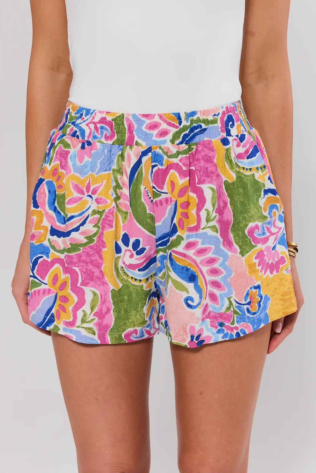 Colorful annie floral shorts worn by a person on a plain background