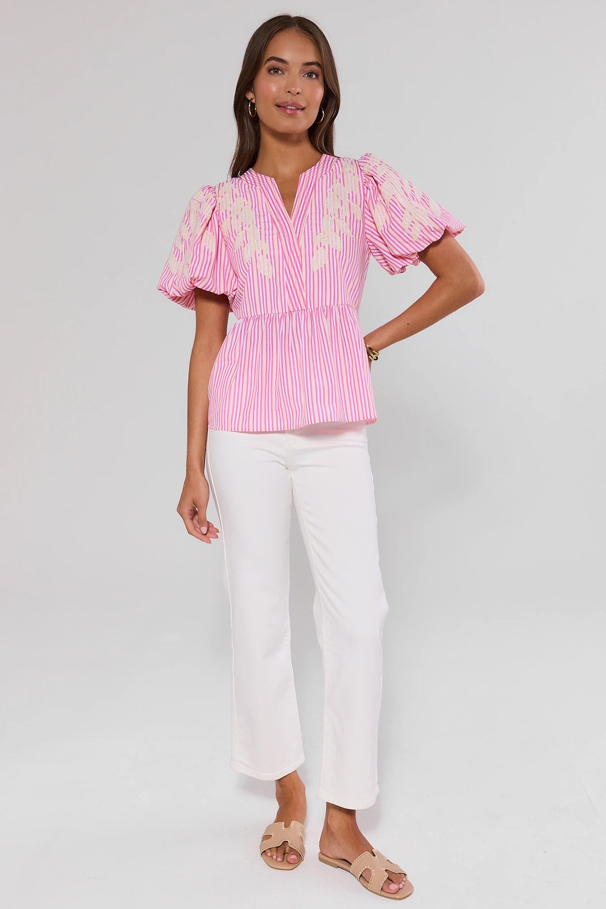 Pink striped peplum top styled with white wide-leg pants and sandals - Full Length | Avara
