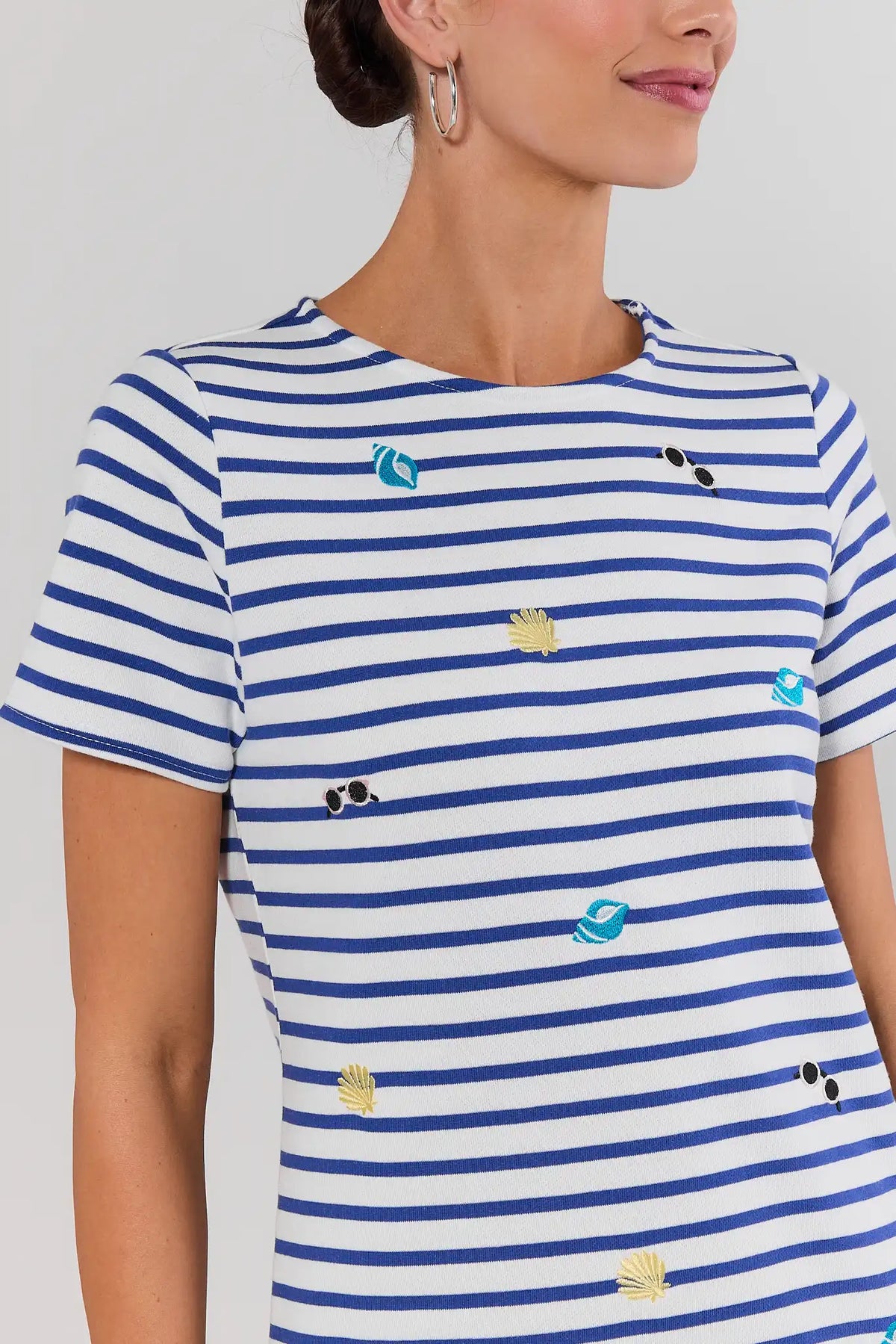 Close-up of blue and white stripe shirt dress with seashell and sunglasses embroidery detail | Avara