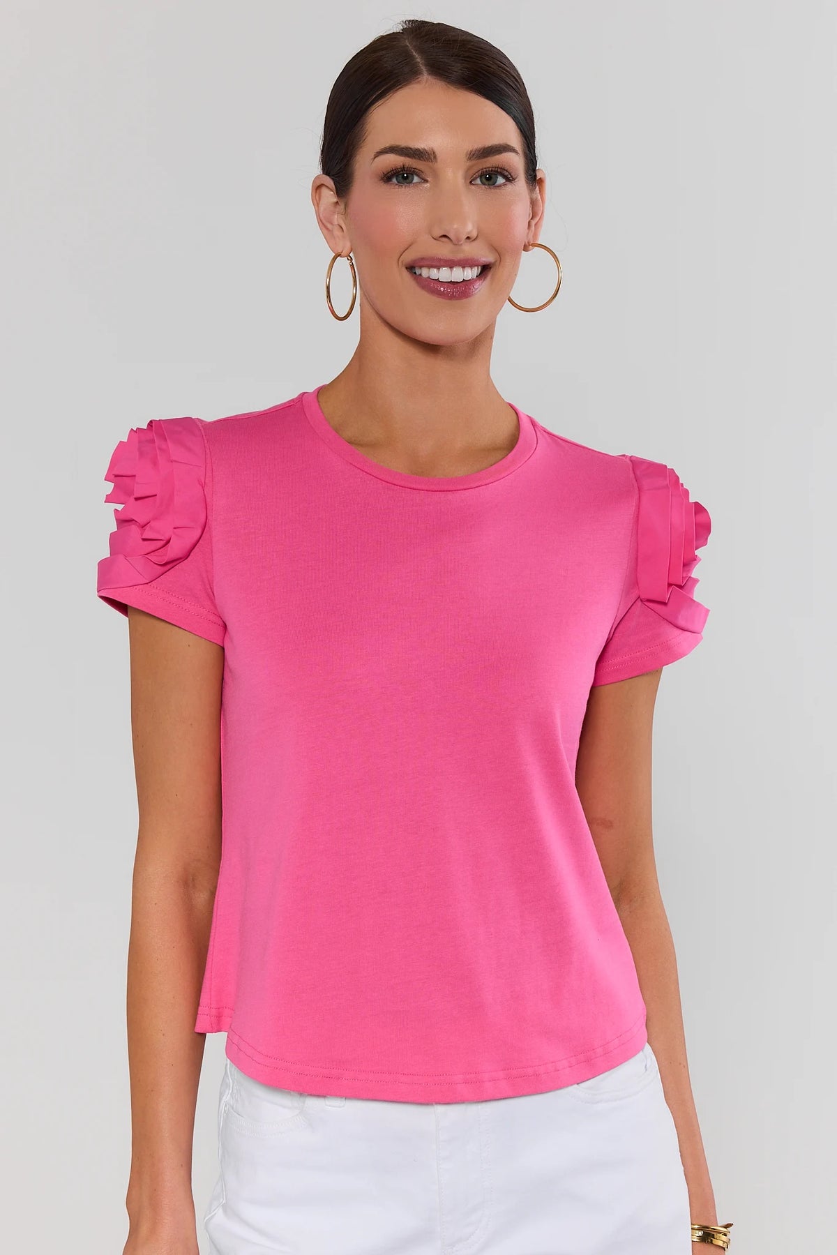 Woman wearing bright pink Kendall Floral Appliqué Top with rosette sleeves - Front View | Avara