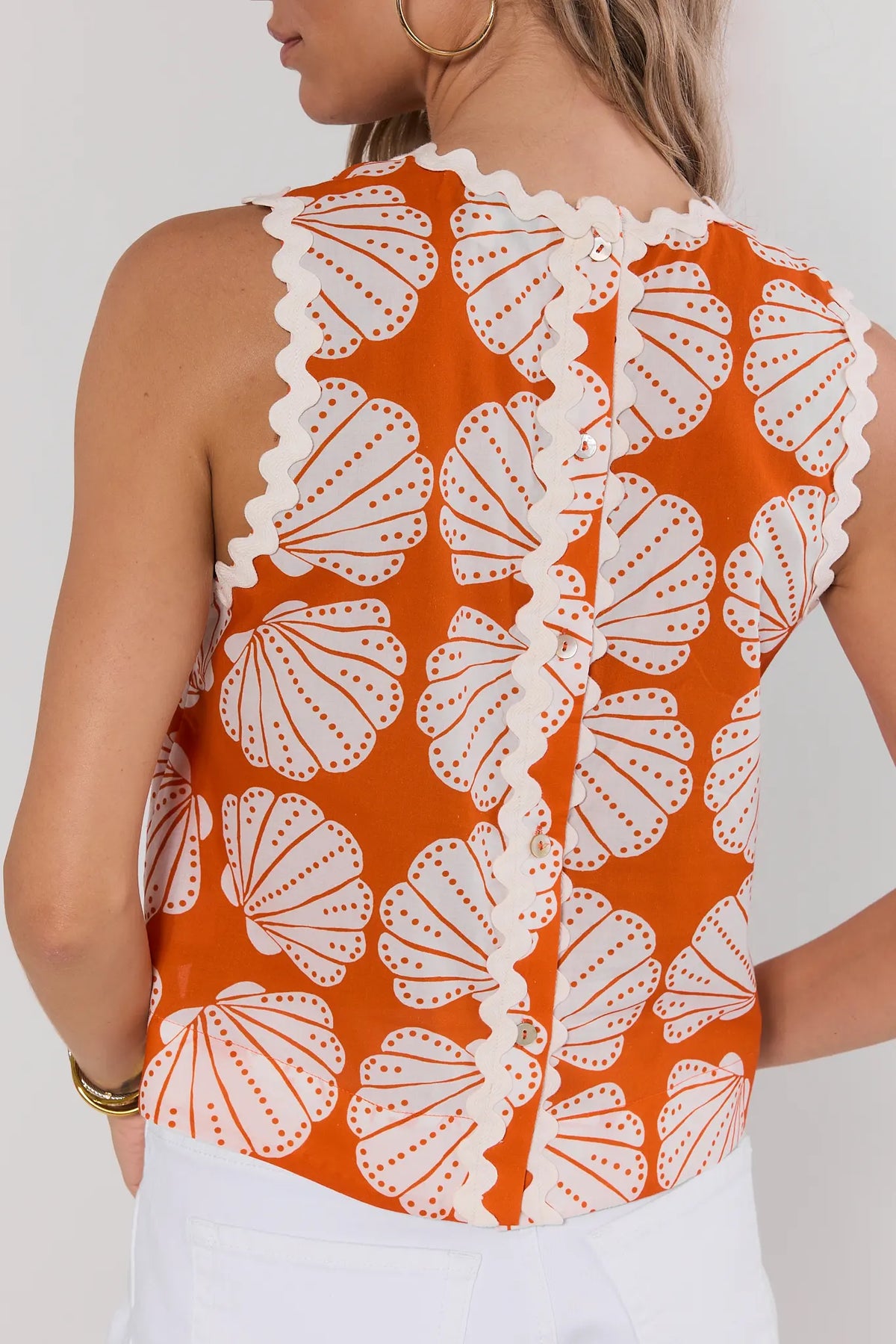 Orange shell print tank top back view showing button closure and white ric-rac trim detail | Avara
