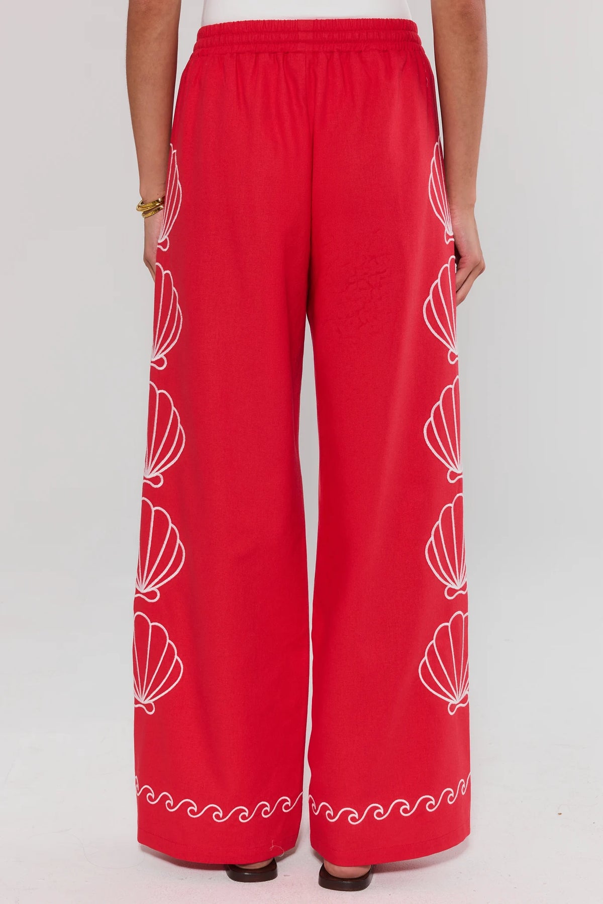 Red pants with white shell pattern on a white background standing
